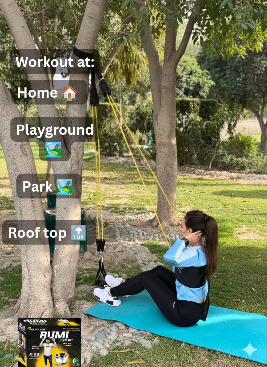 Person exercising on a mat in a park with fitness equipment nearby